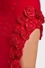 Close-up of satin rosette detailing on red high-slit gown