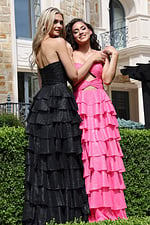 hot pink strapless twist bodice ruffled maxi dress - two girls front, blonde over shoulder brunette hands up