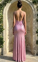 Back view of fitted embellished gown with low open back, thin straps, and softly flared hem