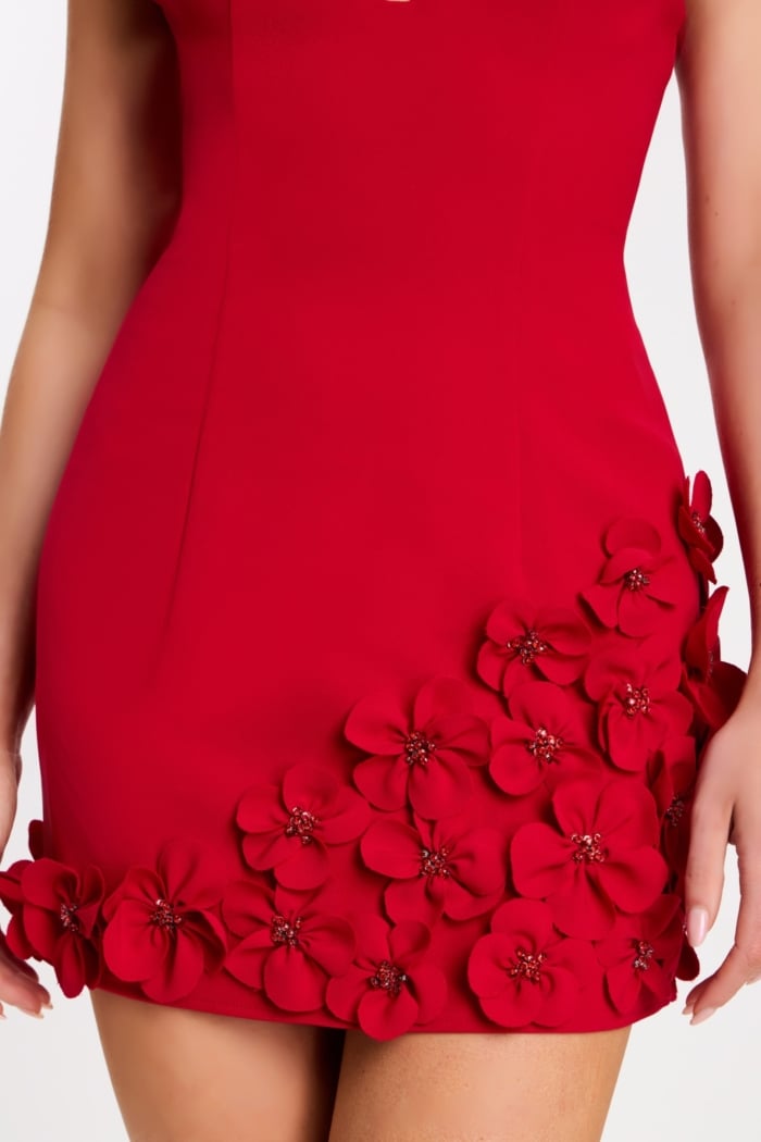 Close-up of black satin rose appliqués on hem of dress