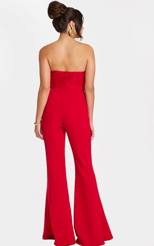 Back view of strapless red flared-leg jumpsuit with center zipper