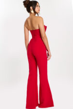 Rear side view of red fitted jumpsuit showing flared pant and open back