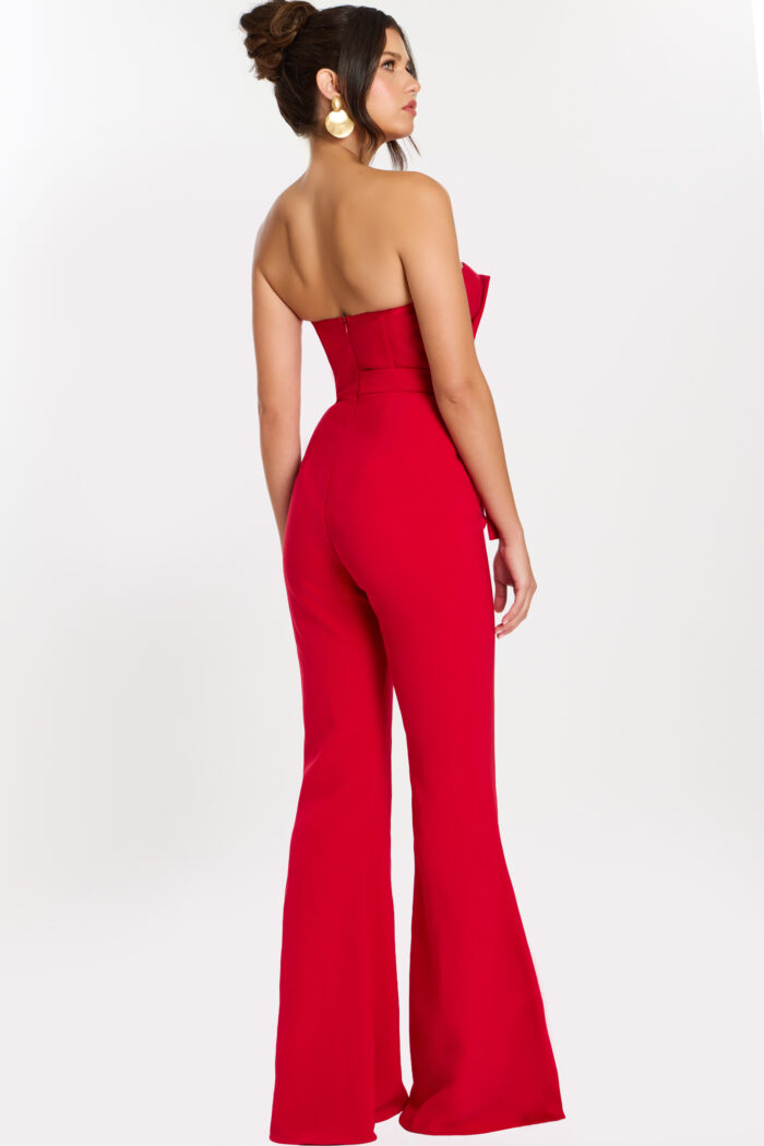 Rear side view of red fitted jumpsuit showing flared pant and open back