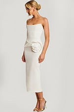 Strapless off-white midi dress with structured bodice and large satin rose detail at the hip