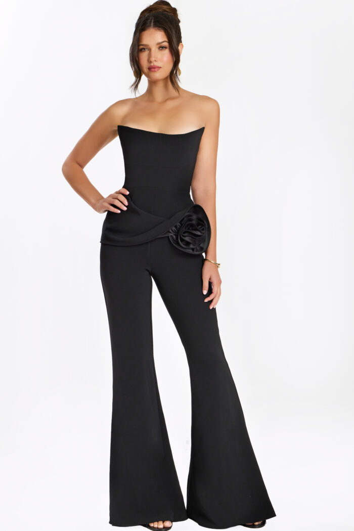 Full view of black strapless jumpsuit with flared legs and sculpted waist