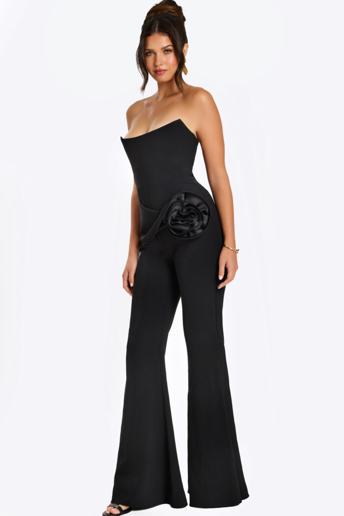 Strapless black jumpsuit with satin rosette detail at the hip