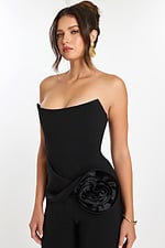 Close-up of structured bodice and floral side accent on black jumpsuit