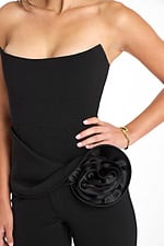 Detailed satin rosette embellishment on black jumpsuit waist