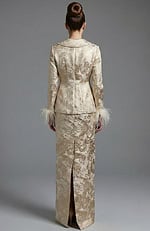 Back view of structured brocade jacket and fitted long skirt with slit