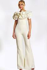 Elegant white jumpsuit with dramatic ruffled shoulders and pearl safety pin accents