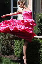 hotpink tiered satin dress with spaghetti straps - front full body, barefoot leaping ruffled skirt