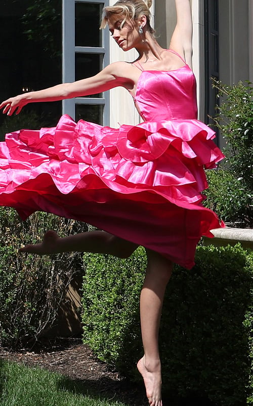 hotpink tiered satin dress with spaghetti straps - front full body, barefoot leaping ruffled skirt