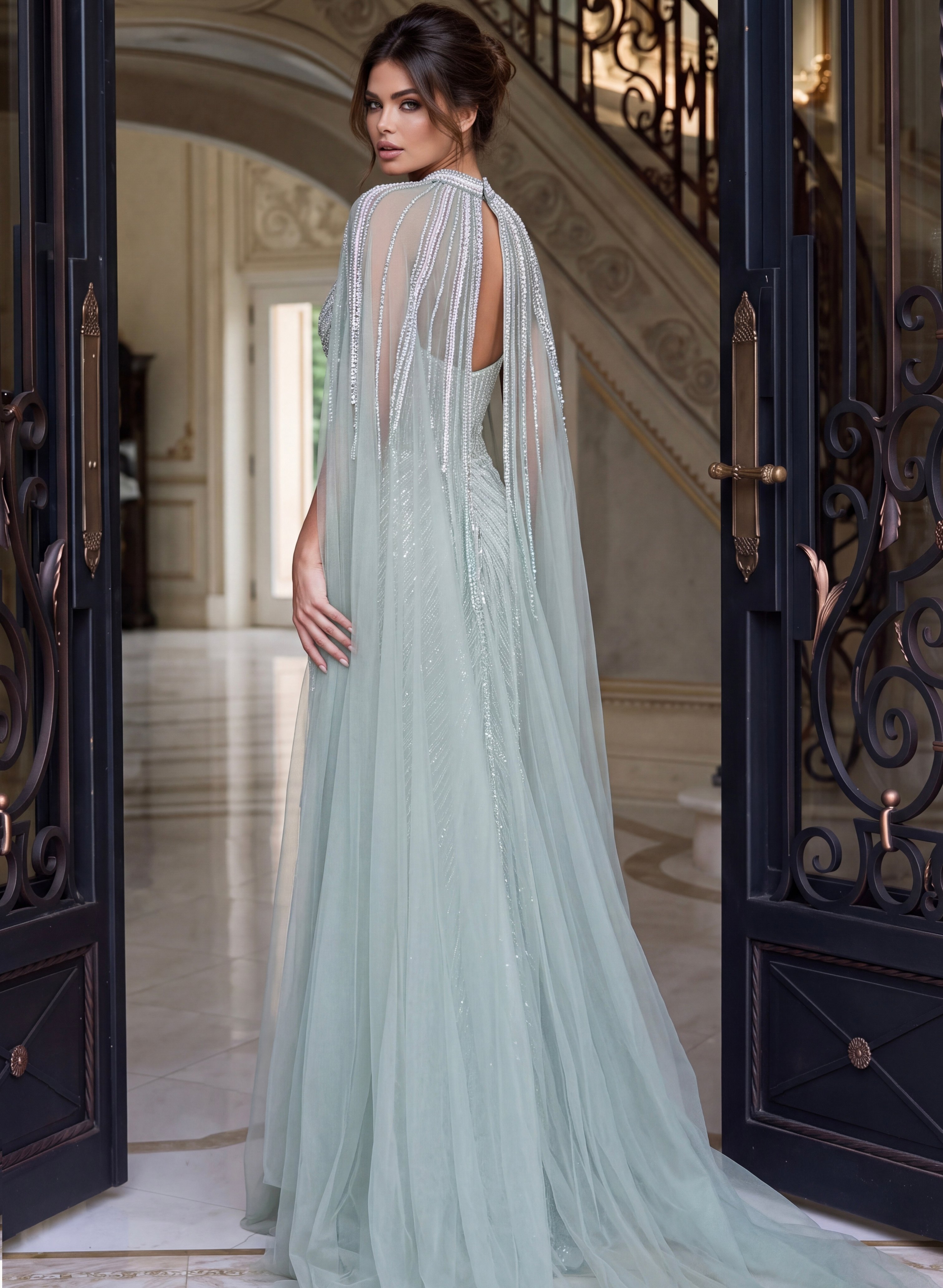 Back view of seafoam beaded mermaid gown showing the cape and beaded skirt