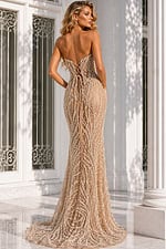 Back view of a champagne beaded evening gown featuring a lace-up corset back, sheer illusion fabric, and intricate pearl-inspired embellishments.