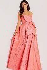 Strapless jacquard gown with metallic gold detailing, sculpted bow accent, and voluminous layered skirt.