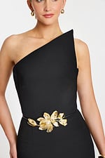 One-shoulder black jumpsuit with wide-leg pants and gold floral waist belt detail.