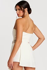 Angled back view showing zipper closure and side detail of the belt