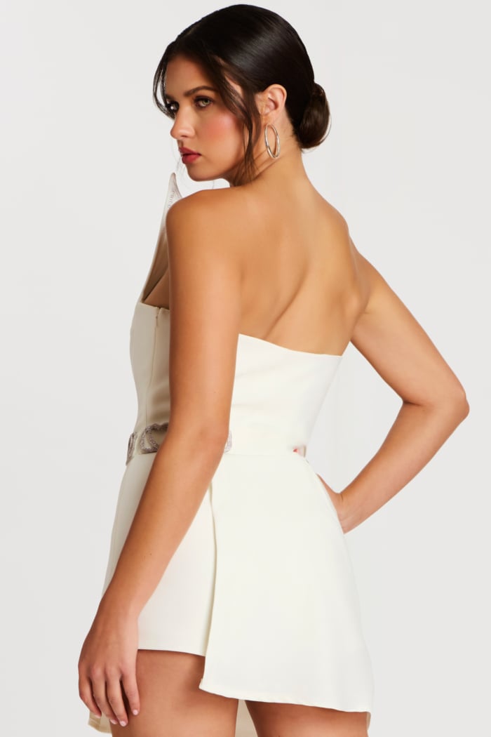 Angled back view showing zipper closure and side detail of the belt