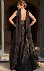 back view of black and gold beaded strapless mermaid gown with cape