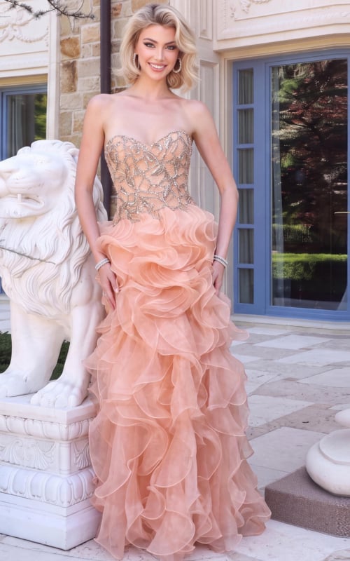 Strapless peach ball gown featuring an embellished sweetheart bodice and voluminous layered ruffle skirt