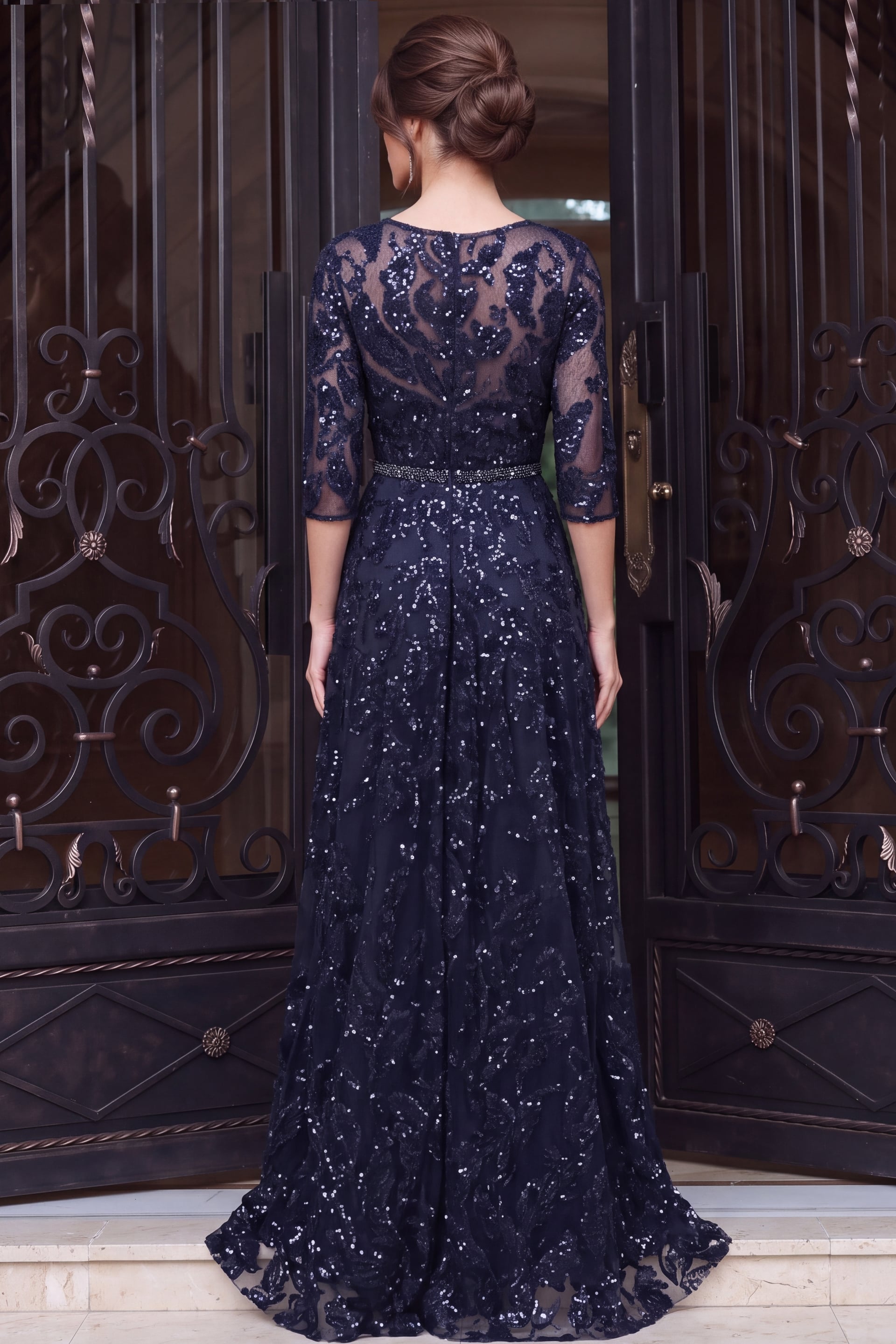 Back view of navy sequin lace gown showing illusion back and full A line skirt