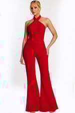 Woman wearing a red halter-neck jumpsuit with wide-leg pants, front view