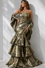 Designer couture mermaid gown in dark olive and gold brocade with sculpted fit, layered ruffles, and sweeping back view.
