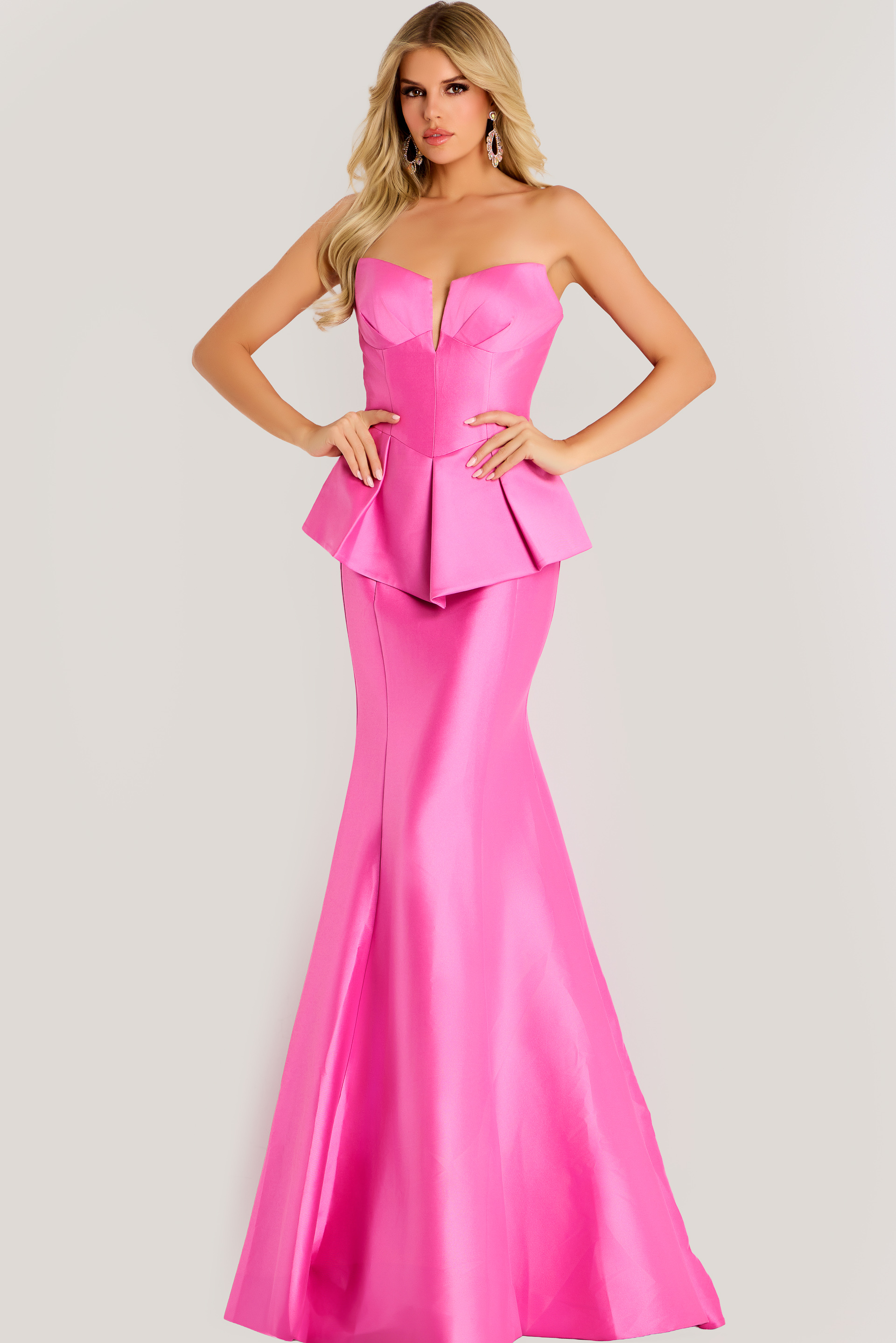 49071 Strapless satin gown with structured peplum bodice and flared mermaid skirt, creating a sleek and elegant silhouette.