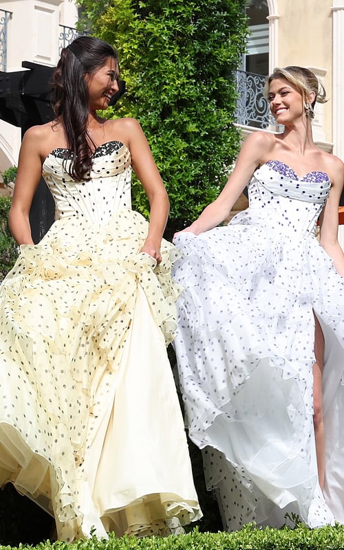 strapless polka dot tiered gown - two girls front, looking at each other holding skirts