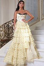 champagne strapless polka dot tiered gown - front full body, hand on hip staircase direct gaze