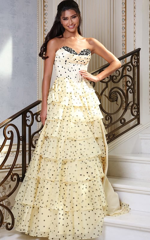 champagne strapless polka dot tiered gown - front full body, smiling hand on hip dark hair on stairs