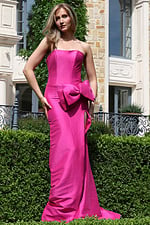 fuchsia strapless dress with bow detail and high slit - front full body, hand on hip prominent bow slit