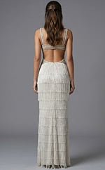 Fitted formal gown featuring intricate beadwork and high slit design