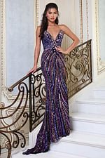 purplemulti strapless sequin gown with deep v and high slit - front full body, standing on stairs holding banister