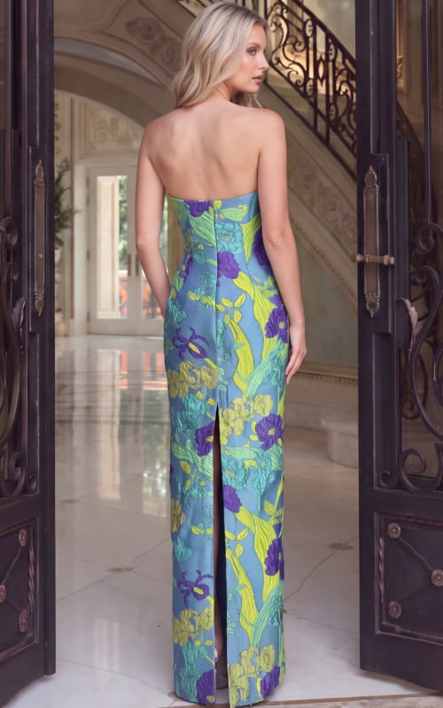 Back view of blue floral brocade gown showing zip back and back slit