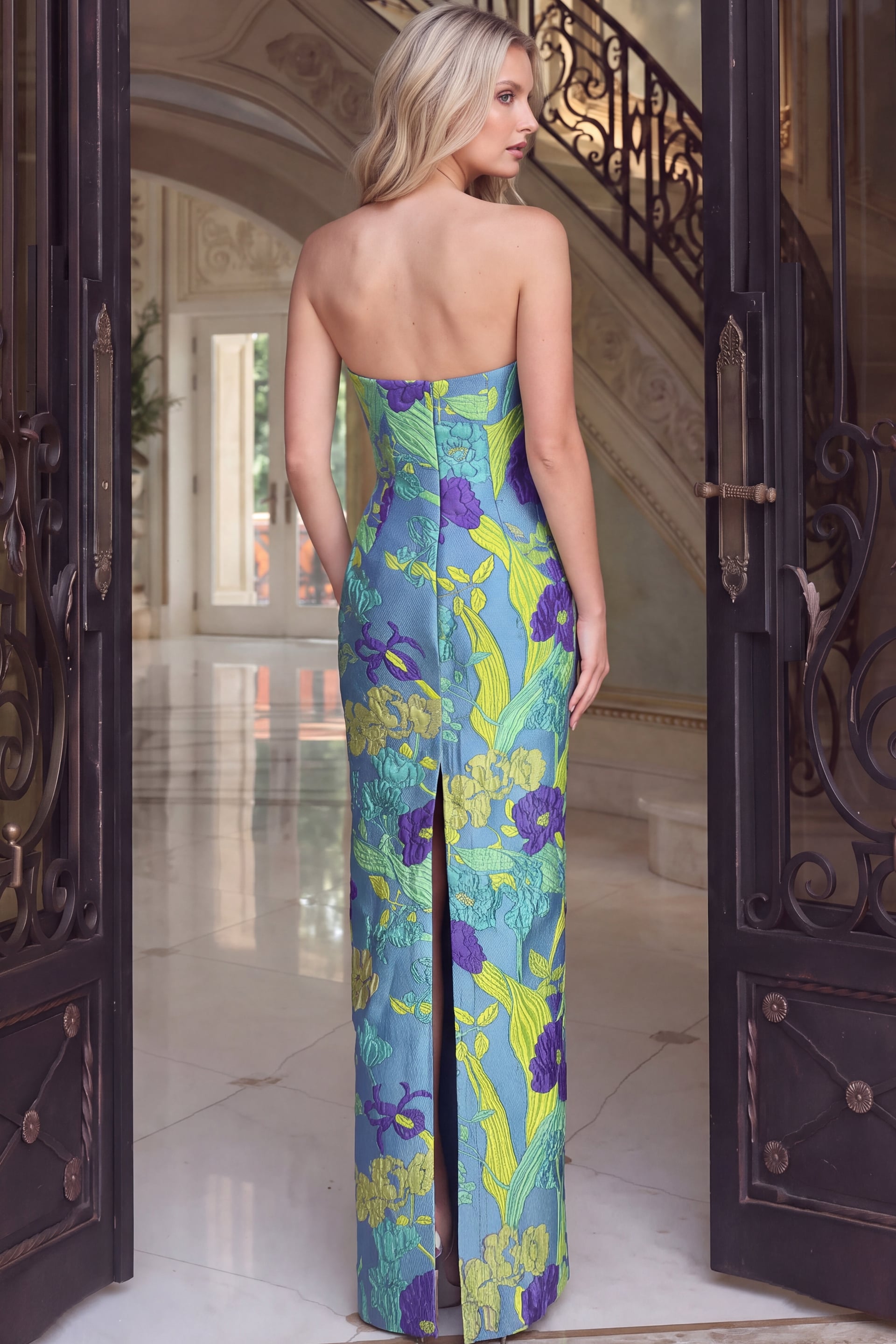 Back view of blue floral brocade gown showing zip back and back slit