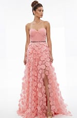 Front view of strapless gown with sweetheart neckline, gathered bodice, and textured appliqué skirt with front slit