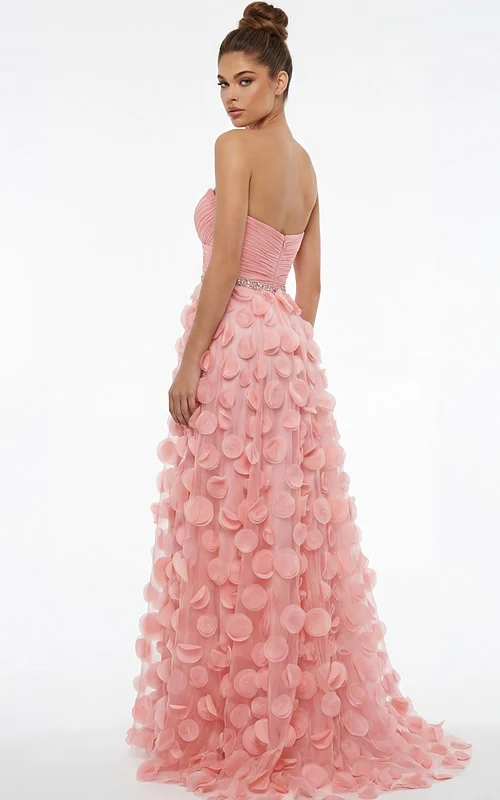 Back view of strapless gown with ruched bodice, beaded waist, and flowing skirt covered in soft circular appliqués