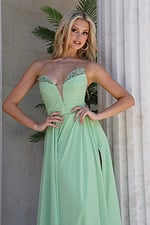 mint strapless coral chiffon a-line gown - three quarter view, hands on hips, blonde wavy hair, large hoop earrings