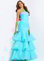 Back view of strapless formal dress with oversized bow and layered skirt.