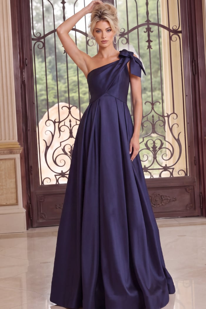 Navy formal gown featuring a one-shoulder bow detail and voluminous A-line silhouette