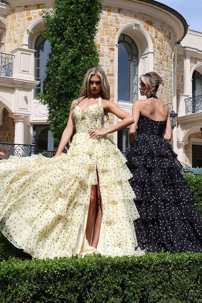 halter polka dot tiered dress with bow bodice - two girls front, blonde slit fanned, black angled
