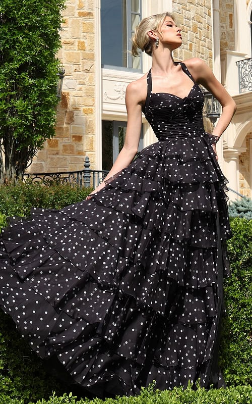 blackwhite halter polka dot tiered dress with bow bodice - front full body, blonde updo, fanned skirt, looking upward
