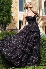 blackwhite halter polka dot tiered dress with bow bodice - front full body, blonde updo, fanned skirt, looking upward