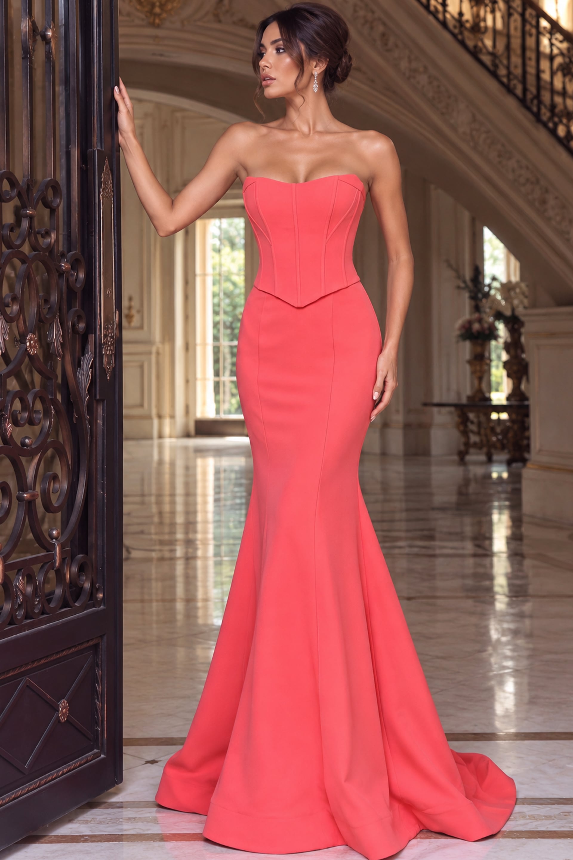 Watermelon strapless corset mermaid gown shown from the front at an angle