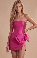 Bright pink cocktail dress with a cinched waist and a horizontal bow embellishment at the hip.