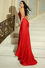 Woman wearing a fitted gown with sweetheart neckline, halter straps, and thigh high slit