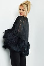 Model wearing Jovani 50364 black dress with lace and feathered trim, back view.