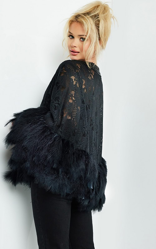 Model wearing Jovani 50364 black dress with lace and feathered trim, back view.
