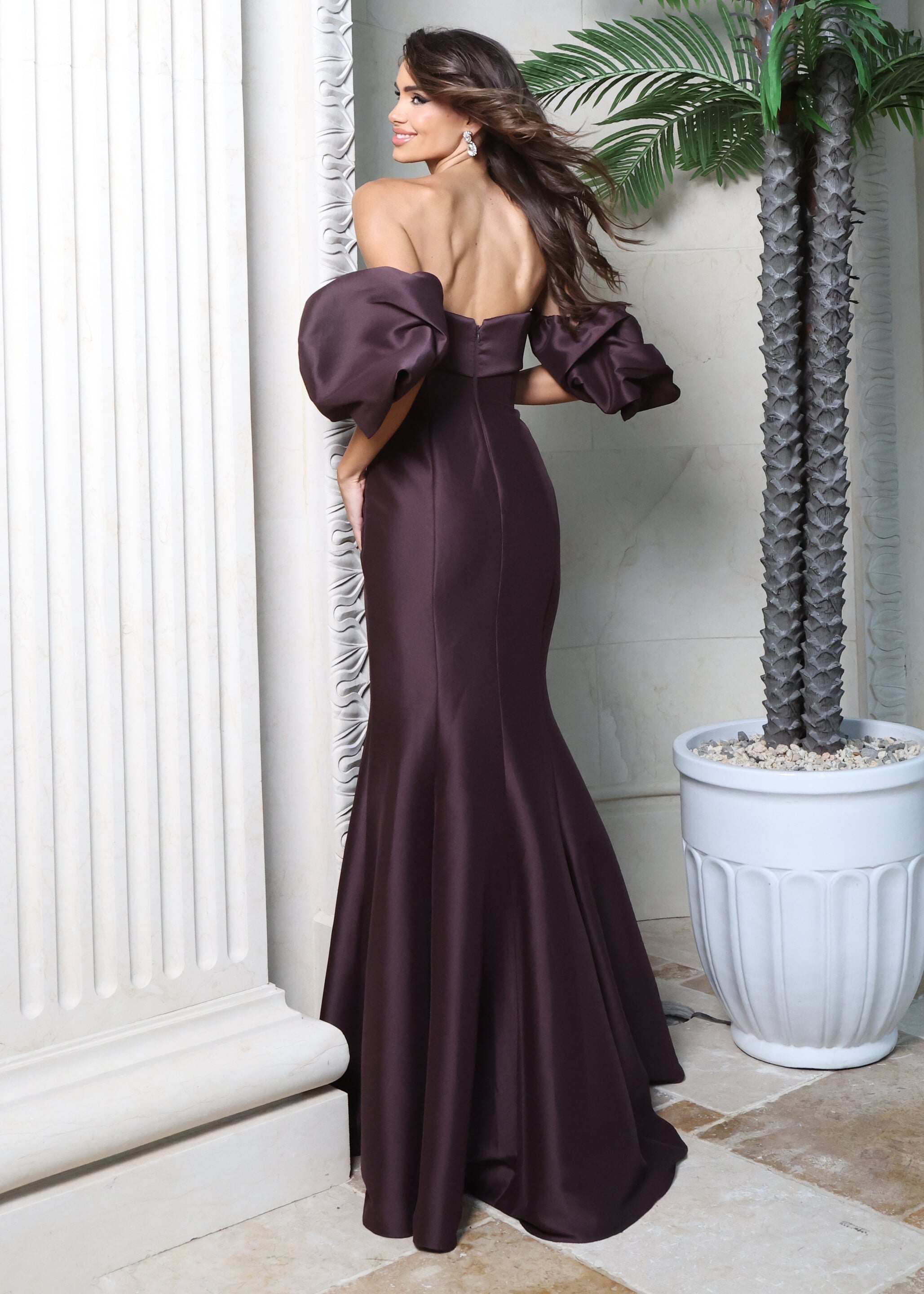 Deep plum off-the-shoulder mermaid gown with oversized puff sleeves, side view